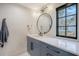 Chic bathroom with blue vanity, modern faucet, and view from the window at 299 Bampfield Dr, Mount Pleasant, SC 29464