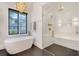 Bright bathroom with freestanding tub, glass-enclosed shower, and modern gold fixtures at 299 Bampfield Dr, Mount Pleasant, SC 29464