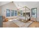 A bright bedroom with a four-poster bed, ceiling fan, and large windows at 299 Bampfield Dr, Mount Pleasant, SC 29464
