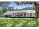Charming single-story home with a metal roof, inviting front porch with a swing, and a well-manicured lawn at 299 Bampfield Dr, Mount Pleasant, SC 29464