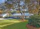Charming home with well-manicured lawn, a metal roof, and a welcoming front porch at 299 Bampfield Dr, Mount Pleasant, SC 29464