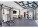 Fully equipped gym with weight machines, punching bag, stationary bike, and glass door for a backyard view at 299 Bampfield Dr, Mount Pleasant, SC 29464