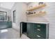 Spacious laundry room with custom cabinets, floating shelves and a dog kennel in the lower cabinet area at 299 Bampfield Dr, Mount Pleasant, SC 29464