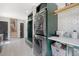 Well-organized laundry room with a stacked washer and dryer, custom cabinets, and a view of the hallway at 299 Bampfield Dr, Mount Pleasant, SC 29464
