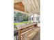 Outdoor dining area features a wooden table and seating, with a view of the pool and basketball court at 299 Bampfield Dr, Mount Pleasant, SC 29464