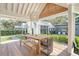 Outdoor dining area features a wood table and seating with a view of the backyard at 299 Bampfield Dr, Mount Pleasant, SC 29464