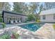 Backyard pool surrounded by lounge chairs, and a garage, perfect for relaxation at 299 Bampfield Dr, Mount Pleasant, SC 29464