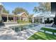 Backyard pool area with a patio, lawn, and lush landscaping on a sunny day at 299 Bampfield Dr, Mount Pleasant, SC 29464
