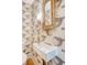 Close-up of a modern powder room featuring a unique sink, faucet, and wallpaper at 299 Bampfield Dr, Mount Pleasant, SC 29464