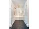 Modern shower boasts white subway tile, herringbone floor, and sleek gold fixtures at 299 Bampfield Dr, Mount Pleasant, SC 29464