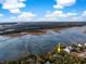 Aerial view of a waterfront property with private dock and beautiful surrounding landscape and coastline at 3034 Maritime Forest Dr, Johns Island, SC 29455