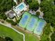 An aerial view showcases the pool, tennis courts, and surrounding greenery of the property at 3034 Maritime Forest Dr, Johns Island, SC 29455