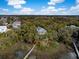 Tranquil aerial view of a waterfront property with a private dock and lush greenery and mature trees at 3034 Maritime Forest Dr, Johns Island, SC 29455
