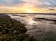Expansive aerial view of waterfront community docks and marshlands under a brilliant sky, showcasing the natural beauty at 3034 Maritime Forest Dr, Johns Island, SC 29455