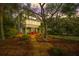 Spacious backyard with mature trees, a swing, and outdoor seating, perfect for leisure and entertaining guests at 3034 Maritime Forest Dr, Johns Island, SC 29455