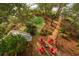 Beautiful backyard with a fire pit and wooden chairs, surrounded by mature trees and landscaping at 3034 Maritime Forest Dr, Johns Island, SC 29455