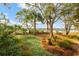 Picturesque backyard with lush landscaping, mature trees, and a tranquil waterfront view for relaxation at 3034 Maritime Forest Dr, Johns Island, SC 29455