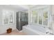Bright bathroom with soaking tub, walk-in shower and plantation shutters for natural light at 3034 Maritime Forest Dr, Johns Island, SC 29455