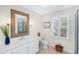 Well-lit bathroom featuring a white vanity, framed mirror, and walk-in shower at 3034 Maritime Forest Dr, Johns Island, SC 29455