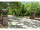 Private community entrance with brick pillars, wrought iron gate, and mature trees ensuring security and exclusivity at 3034 Maritime Forest Dr, Johns Island, SC 29455