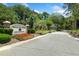 Elegant community entrance with decorative signage, colorful flowers, and lush landscaping that enhances curb appeal at 3034 Maritime Forest Dr, Johns Island, SC 29455