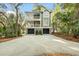 A beautifully designed home featuring a double garage and a charming porch on both floors at 3034 Maritime Forest Dr, Johns Island, SC 29455