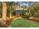 Beautiful multi-story home with a screened porch, lawn, and multiple trees at 3034 Maritime Forest Dr, Johns Island, SC 29455