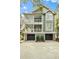 Stunning three-story home featuring double porches, a three-car garage, and meticulous landscaping under mature trees at 3034 Maritime Forest Dr, Johns Island, SC 29455