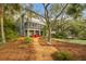 Charming two-story home with a screened porch and inviting outdoor seating area at 3034 Maritime Forest Dr, Johns Island, SC 29455