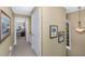 Inviting hallway with beige walls, carpet, and arched window offering ample natural light at 3034 Maritime Forest Dr, Johns Island, SC 29455