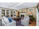 Bright living room with fireplace, hardwood floors, and access to outdoor spaces at 3034 Maritime Forest Dr, Johns Island, SC 29455