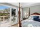 Bright main bedroom featuring a balcony, four poster bed, and ample natural light at 3034 Maritime Forest Dr, Johns Island, SC 29455