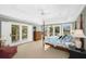 Light-filled main bedroom with balcony access, tray ceilings, and stylish furnishings at 3034 Maritime Forest Dr, Johns Island, SC 29455