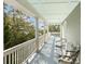 Covered porch with comfortable seating and serene views at 3034 Maritime Forest Dr, Johns Island, SC 29455