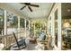 Relaxing screened porch featuring comfortable seating arrangements and scenic waterfront vistas at 3034 Maritime Forest Dr, Johns Island, SC 29455