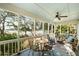 Inviting screened porch with comfortable seating and scenic waterfront views for relaxing and entertaining at 3034 Maritime Forest Dr, Johns Island, SC 29455