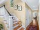 Traditional staircase with white banisters, wooden steps, and a cozy basket accent at 3034 Maritime Forest Dr, Johns Island, SC 29455