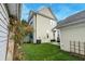 Spacious backyard with artificial turf and patio with outdoor seating and landscaping at 312 White Gables Dr, Summerville, SC 29483