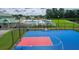 Community basketball court with blue surface, red key, and black chain link fencing near pool area at 312 White Gables Dr, Summerville, SC 29483