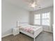 Bright bedroom with a white frame bed, patterned bedding, and natural light from two windows at 312 White Gables Dr, Summerville, SC 29483