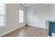 Minimalist bedroom with wood flooring, large windows, and a touch of artistic flair with framed wall art at 312 White Gables Dr, Summerville, SC 29483