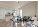 Open dining area with view to kitchen and living room, featuring wood table and black leather sofa at 312 White Gables Dr, Summerville, SC 29483