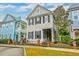 Charming two-story home with inviting front porch and manicured landscaping and an adjacent building at 312 White Gables Dr, Summerville, SC 29483