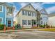 A charming two-story home boasting a yellow exterior, black shutters, and a welcoming front porch at 312 White Gables Dr, Summerville, SC 29483