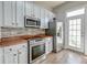 Bright kitchen with stainless steel appliances, butcher block countertops, and light wood floors at 312 White Gables Dr, Summerville, SC 29483