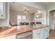 Modern kitchen featuring wood countertops, stainless steel appliances, and an open layout to the living room at 312 White Gables Dr, Summerville, SC 29483