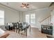Comfortable living room features wood floors, a ceiling fan, with plenty of natural light from large windows at 312 White Gables Dr, Summerville, SC 29483
