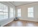 Bright living room with three large windows, wood-look flooring, and fresh, neutral paint at 312 White Gables Dr, Summerville, SC 29483