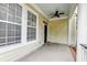 Covered porch with a fan and ample natural light from large windows, offering a cozy outdoor space at 312 White Gables Dr, Summerville, SC 29483