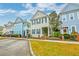 A charming street with a row of well-maintained homes, showcasing colorful facades and verdant lawns at 312 White Gables Dr, Summerville, SC 29483